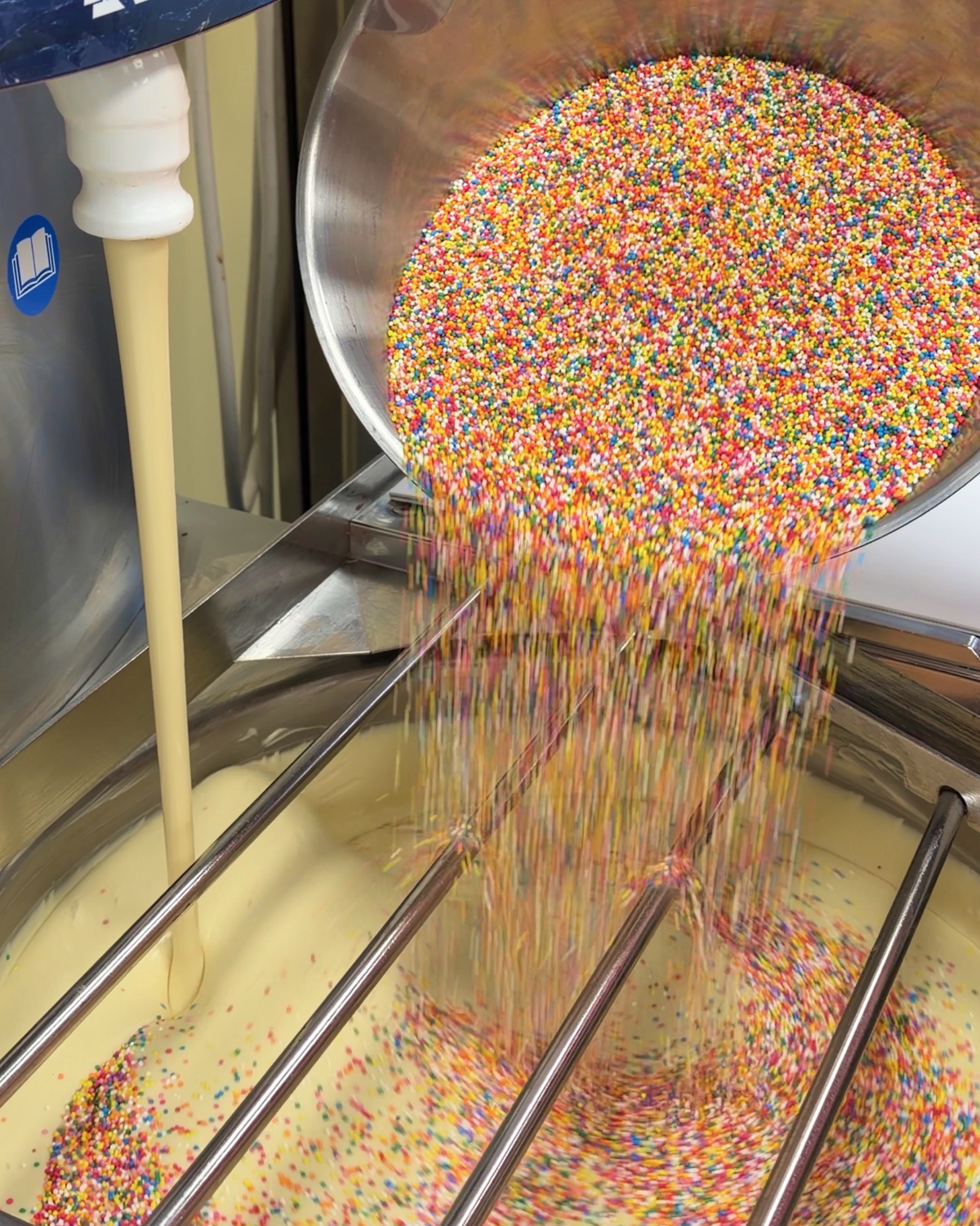 Sprinkles pouring from bowl into white chocolate 